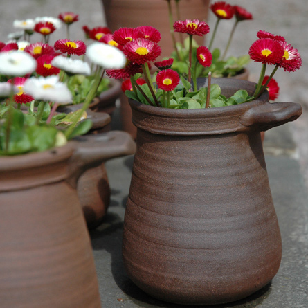 Patia Davis wood-fired terracotta plant pot with flowers